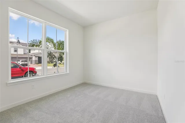 a view of an empty room and closet area