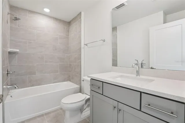a bathroom with a sink vanity and a mirror