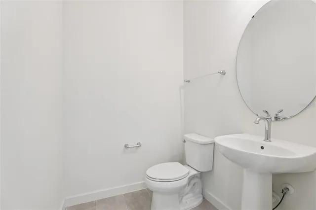 a bathroom with a sink a mirror and toilet