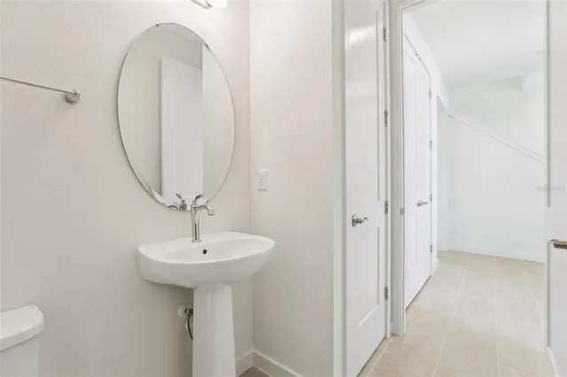 a view of a big room with fan and windows