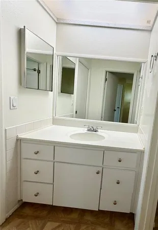 a bathroom with a double vanity sink and mirror