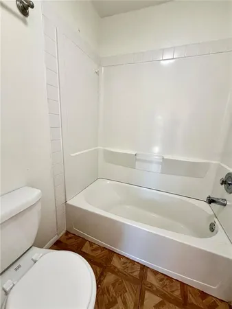 a bathroom with a toilet and a bathtub