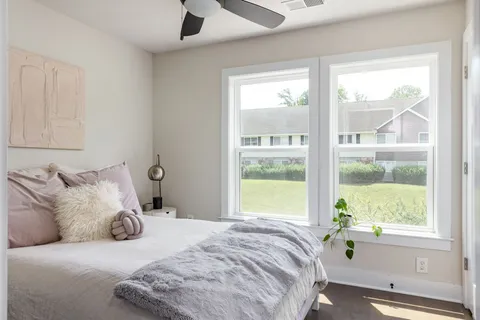 a bedroom with a bed and a window