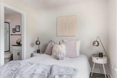 a bedroom with a bed and a lamp