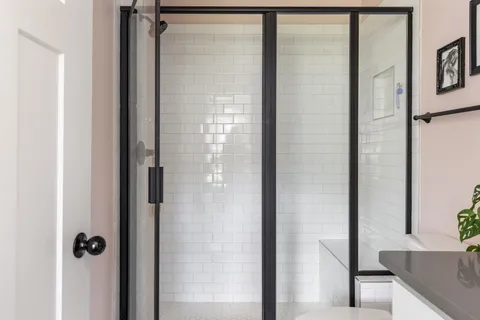 a bathroom with a glass shower door