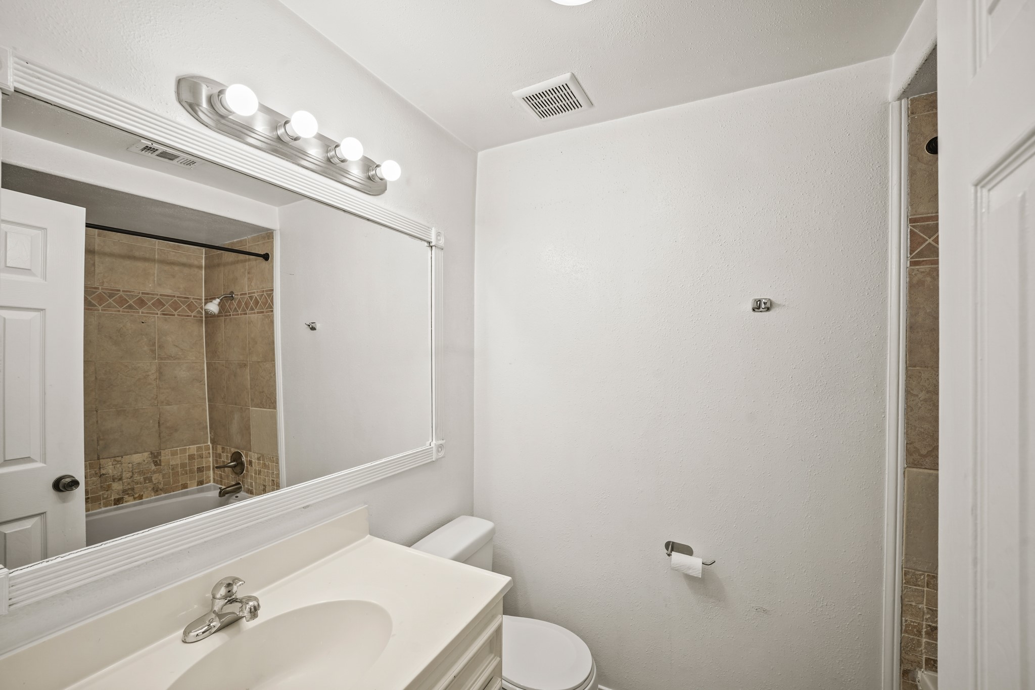 1539 Hawthorne Street, Unit 3 Houston, TX 77006 - Photo 7 of 11 a bathroom with a sink a mirror and a toilet
