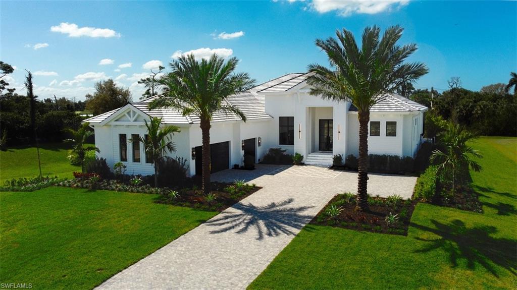 15850 Hampton View Fort Myers, FL 33908 - Photo 1 of 38 View of front facade with decorative driveway, a front yard, a garage, and stucco siding
