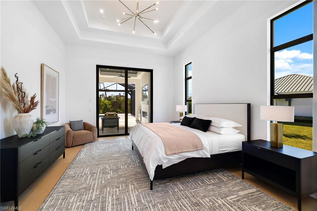 15850 Hampton View Fort Myers, FL 33908 - Photo 16 of 38 Bathroom featuring a walk in shower, two vanities, a freestanding bath, and plenty of natural light