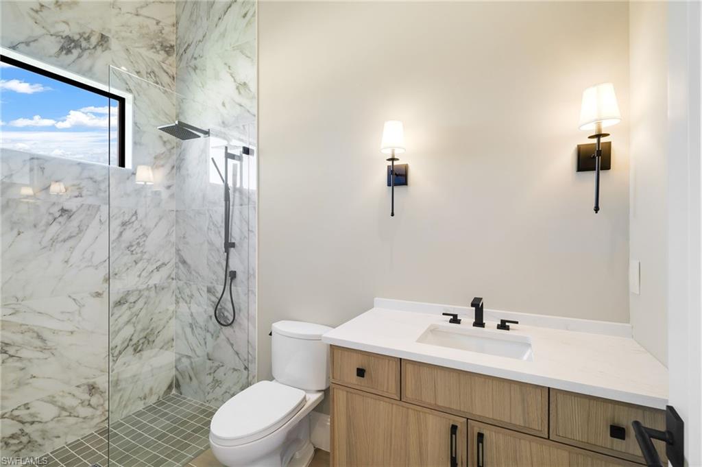 15850 Hampton View Fort Myers, FL 33908 - Photo 25 of 38 Bathroom featuring vanity and a marble finish shower