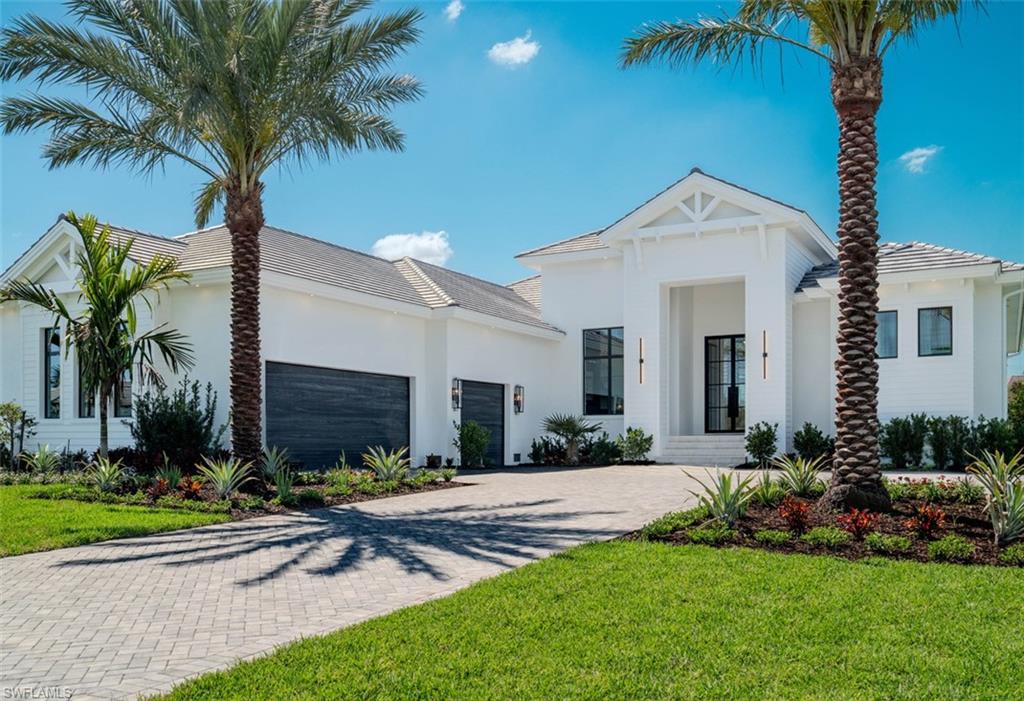 15850 Hampton View Fort Myers, FL 33908 - Photo 3 of 38 View of front of home featuring decorative driveway, stucco siding, a front yard, and an attached garage