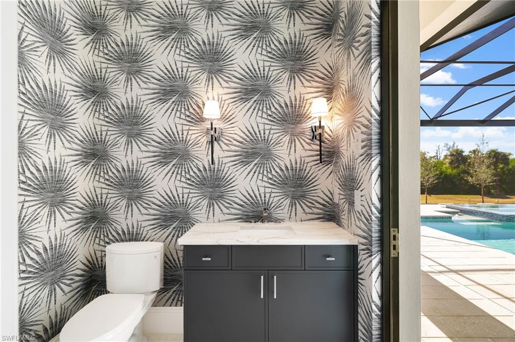 15850 Hampton View Fort Myers, FL 33908 - Photo 31 of 38 Integrated pool / S spa featuring I a sunroom, a lanai, a patio area, and outdoor dining space