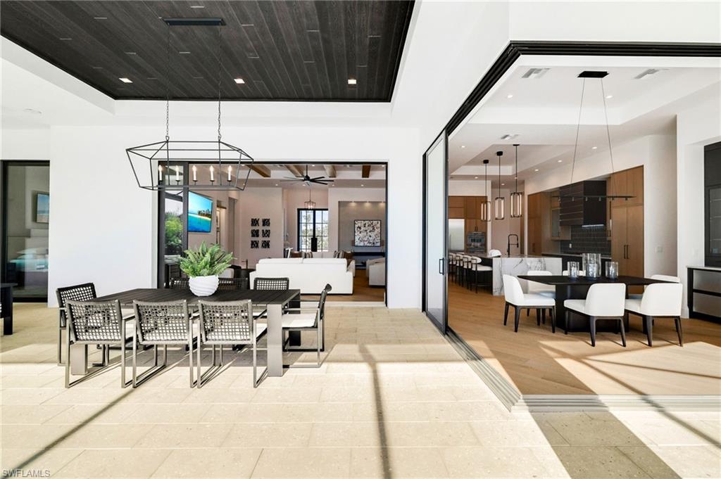 15850 Hampton View Fort Myers, FL 33908 - Photo 32 of 38 View of patio / terrace with area for grilling, a ceiling fan, a sunroom, a pool with connected hot tub, and outdoor lounge area