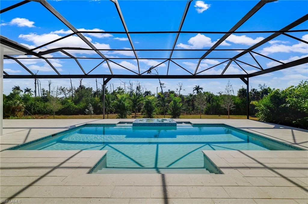 15850 Hampton View Fort Myers, FL 33908 - Photo 37 of 38 Integrated pool / hot tub featuring a sunroom, a lanai, and a patio area