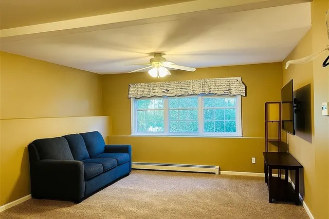 a view of house with yard and sitting area