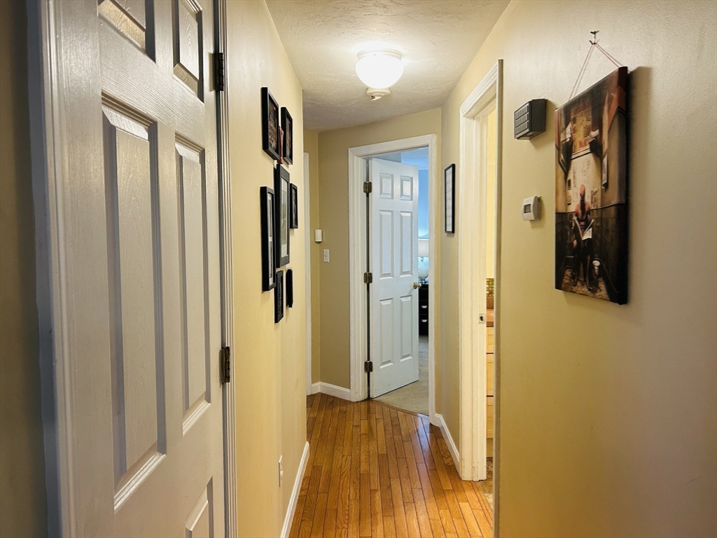 53 Denver Terrace Worcester, MA 01604 - Photo 11 of 19 a view of a hallway with wooden floor and staircase