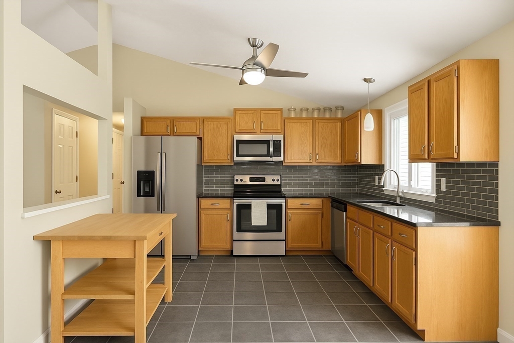 53 Denver Terrace Worcester, MA 01604 - Photo 6 of 19 a kitchen with stainless steel appliances granite countertop a refrigerator a stove top oven a sink and dishwasher