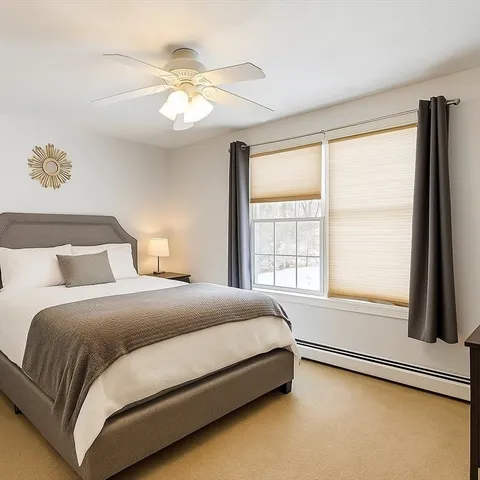 a bedroom with a large bed and a large window