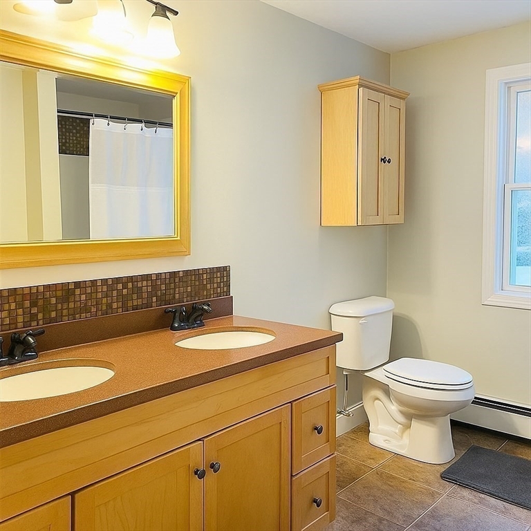 53 Denver Terrace Worcester, MA 01604 - Photo 10 of 19 a bathroom with a sink a toilet and a mirror