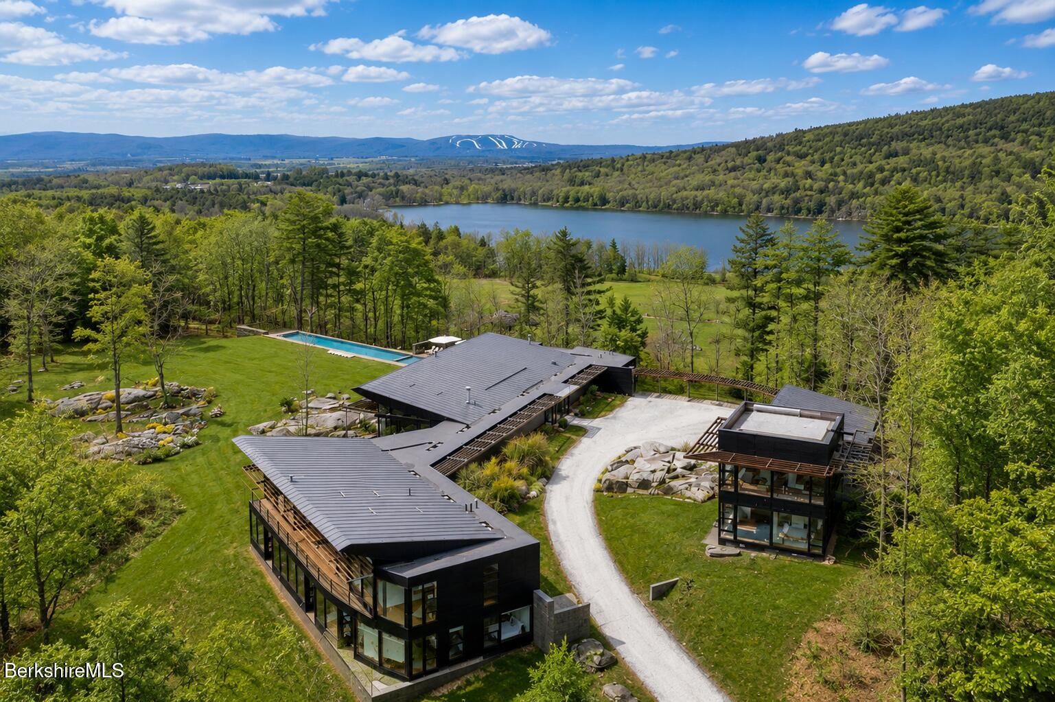 250 Long Pond Road Great Barrington, MA 01230 - Photo 2 of 56 an aerial view of a house with pool lake view and mountain view