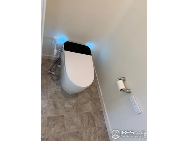 a bathroom with a toilet and a mirror
