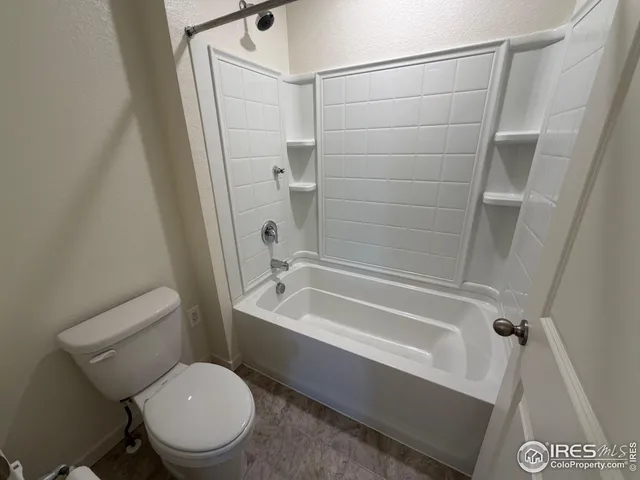 a bathroom with a toilet and a bathtub
