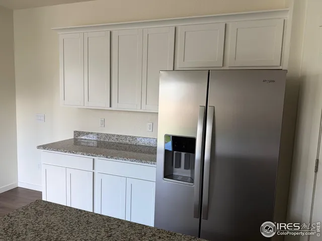 a kitchen with cabinets and stainless steel appliances