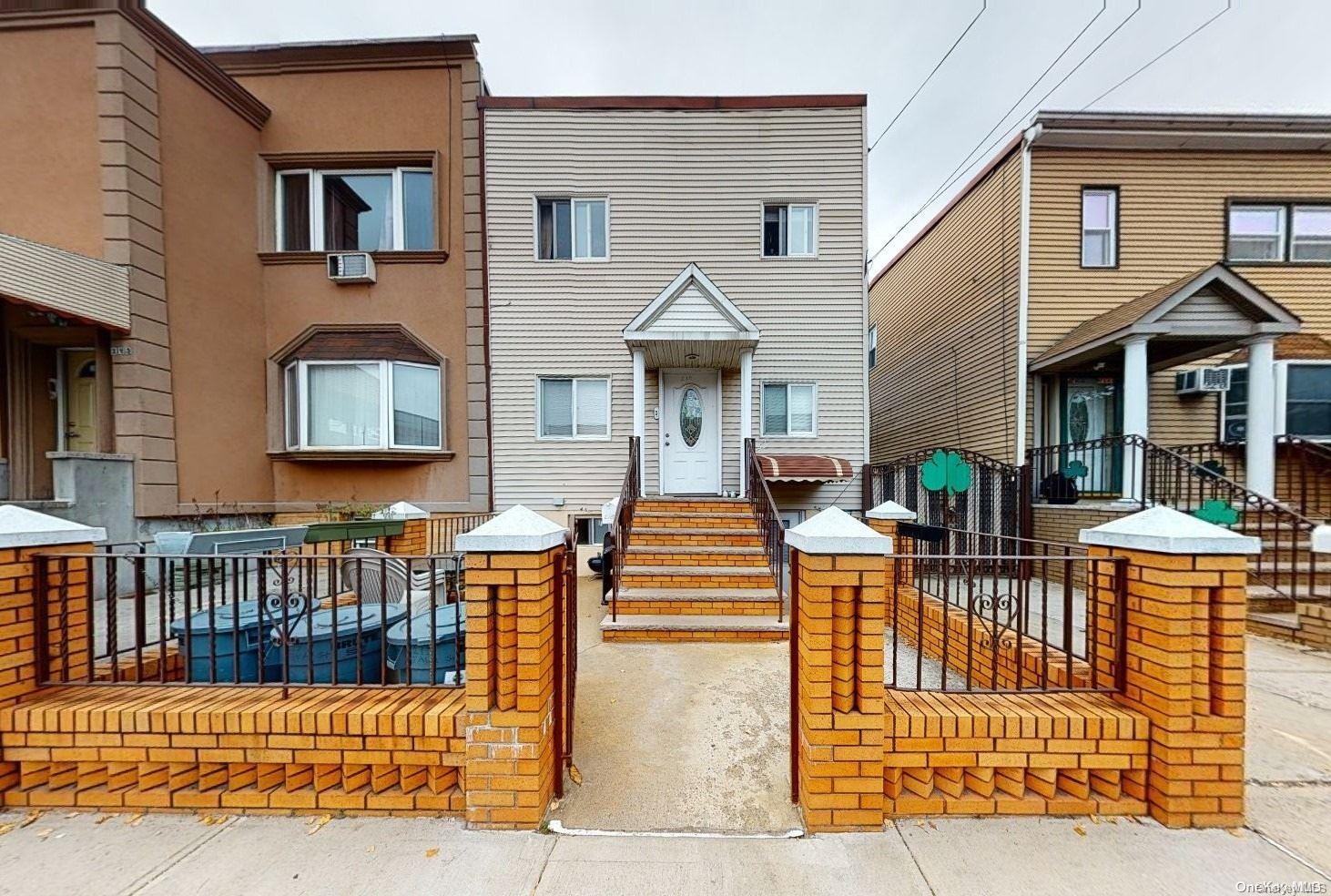 a view of a brick house with large windows and furniture