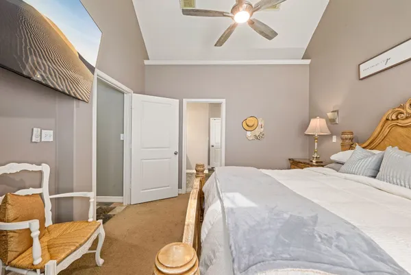 a bedroom with a bed and chandelier