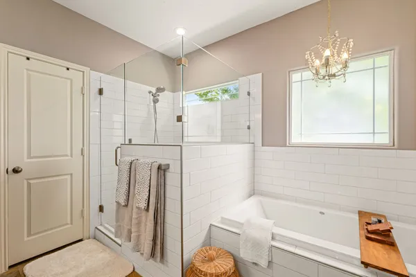 a bathroom with a shower a sink and a mirror