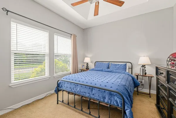 a bedroom with a bed a closet and window