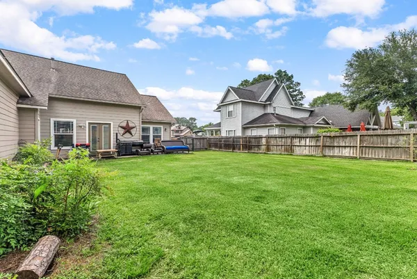 a view of a house with a big yard and large trees