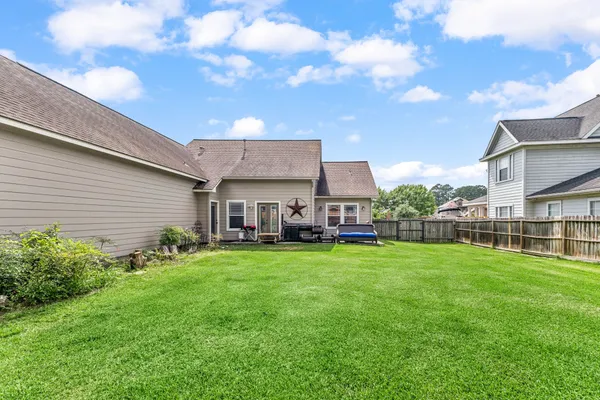 a view of a house with backyard and porch