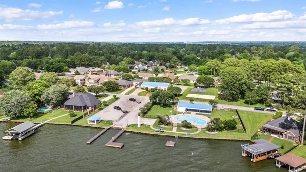 an aerial view of a houses with a yard