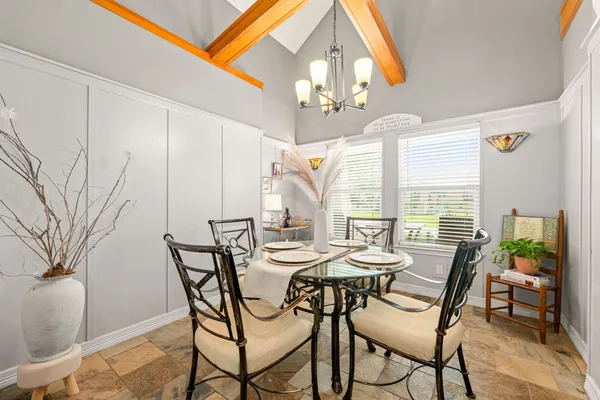 a view of a dining room with furniture and a chandelier