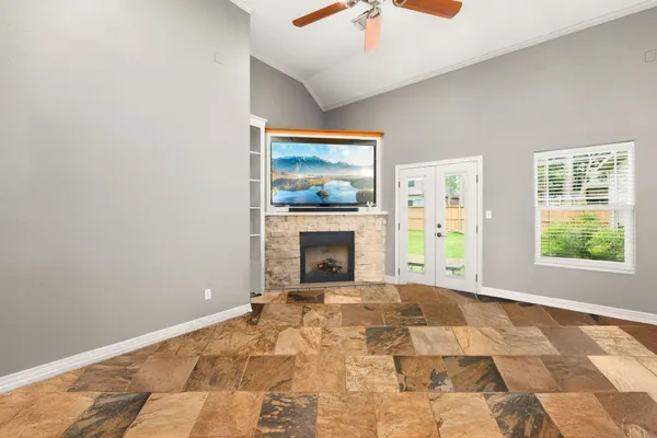 a view of a livingroom with a fireplace and window