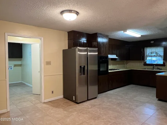 a kitchen with a refrigerator and a sink