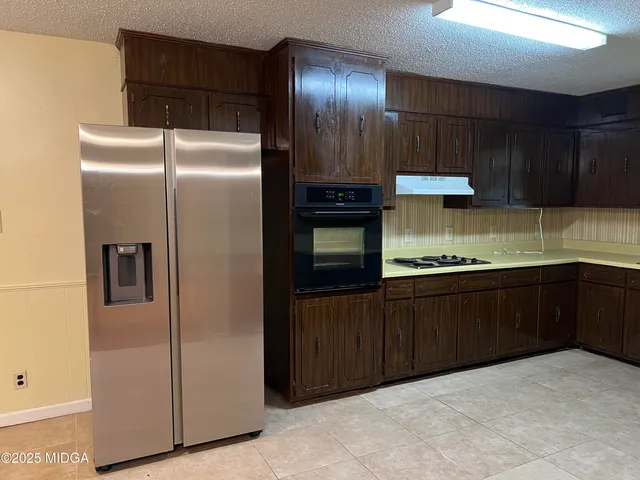 a kitchen with a sink and a stove