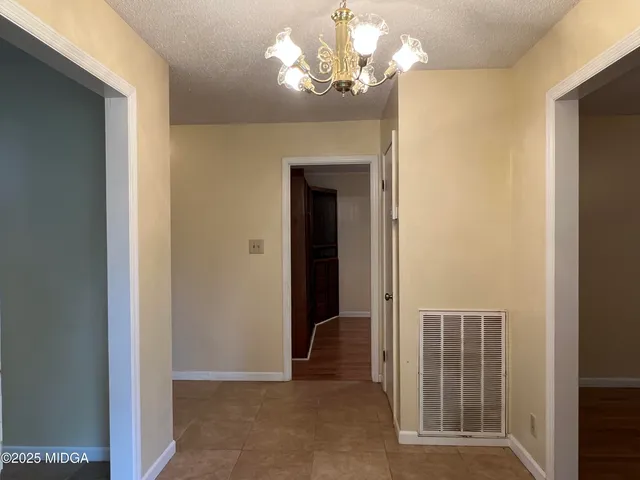 a view of a hallway with chandelier