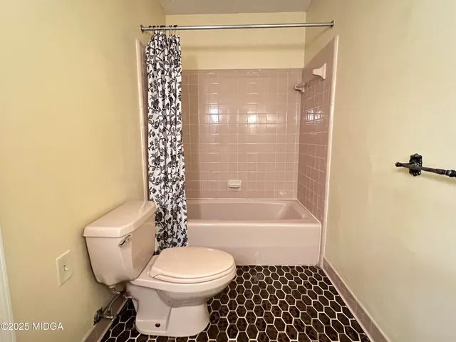 an empty room with a window and a ceiling fan