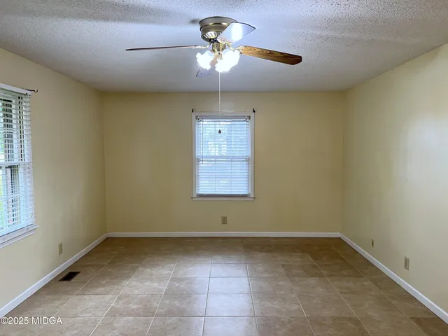 a view of room with window and ceiling fan
