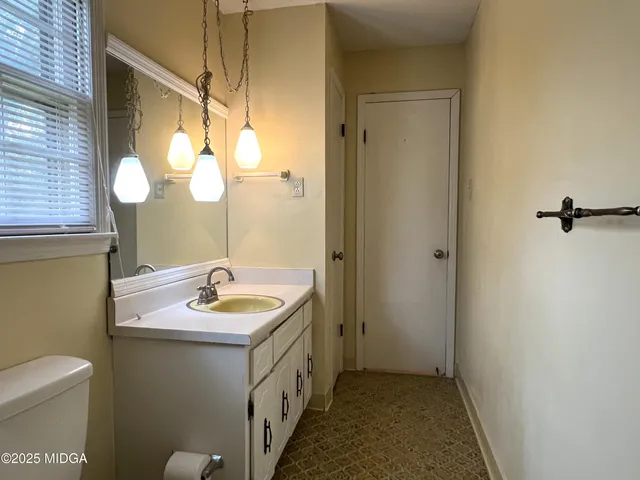 an empty room with closet and fan