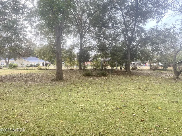 a backyard of a house with lots of green space