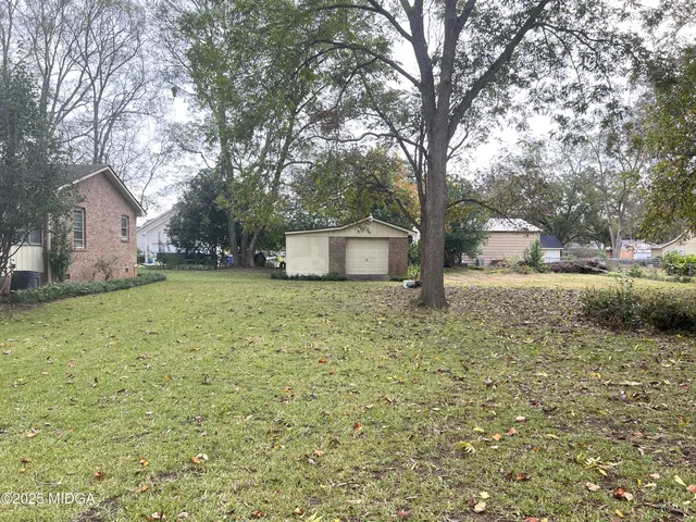 a house view with a backyard space