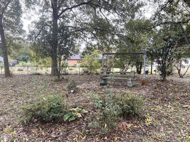 a front view of a house with a yard garage and outdoor seating