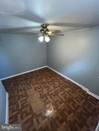 a view of a big room with wooden floor and fan