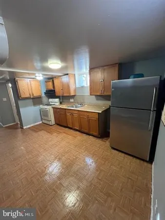 a room with refrigerator and cabinets