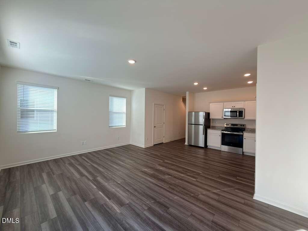 2048 Trailside Drive Durham, NC 27704 - Photo 14 of 27 a view of a kitchen with kitchen island wooden floor appliances and cabinets