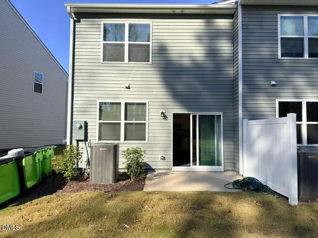 a view of the house with backyard and trees