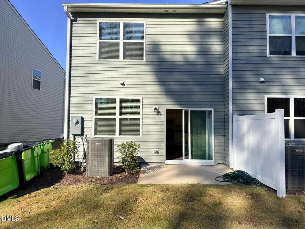 2048 Trailside Drive Durham, NC 27704 - Photo 26 of 27 a view of a house with potted plants and a table and chairs