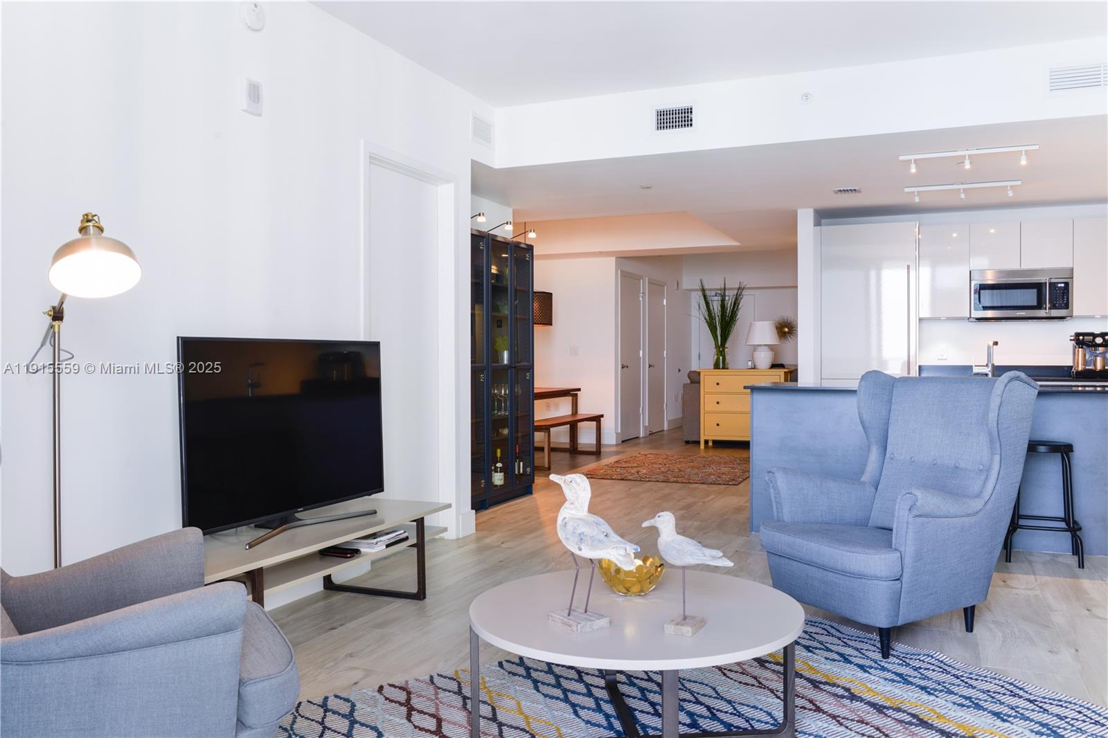 1010 Brickell Avenue, Unit 3002 Miami, FL 33131 - Photo 9 of 39 a living room with couches and a flat screen tv